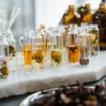 Close-up of various aromatic floral oils in glass bottles, showcasing their vibrant colors and natural ingredients.